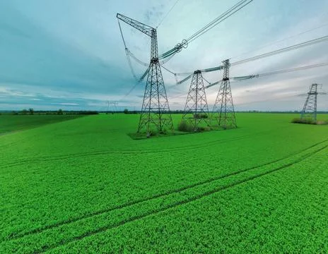 High voltage tower construction in green gield, beautiful landscape, blue sky Stock Photos