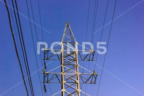 High voltage tower. Electric pole on blue sky background. The problem of ecol Stock Photos