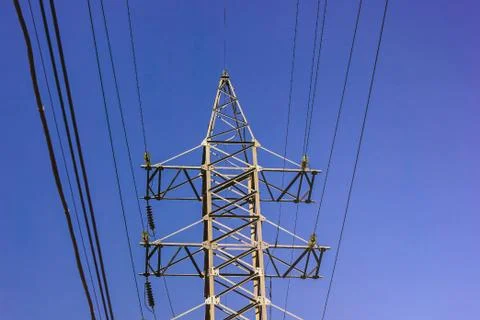 High voltage tower. Electric pole on blue sky background. The problem of ecol Stock Photos