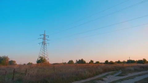 High-voltage tower in a field against the blue sky. High voltage tower. Static Stock-Footage 262534733