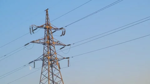 High-voltage tower in a field against the blue sky. High voltage tower. Static Stock-Footage 262770122
