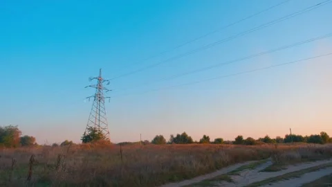 High voltage tower. High-voltage tower in a field against the blue sky. Static Video stock 261221487