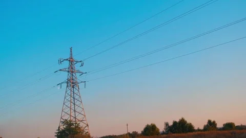 High voltage tower. High-voltage tower in a field against the blue sky. Static Video stock 261221526