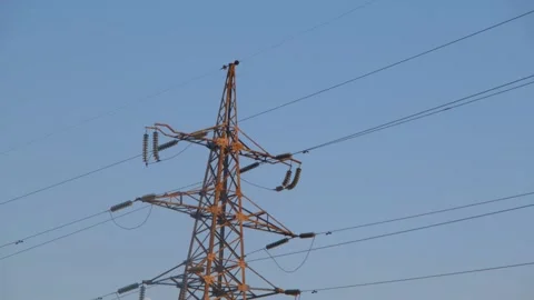 High voltage tower. High-voltage tower in a field against the blue sky. Static Stock-Footage 262534735
