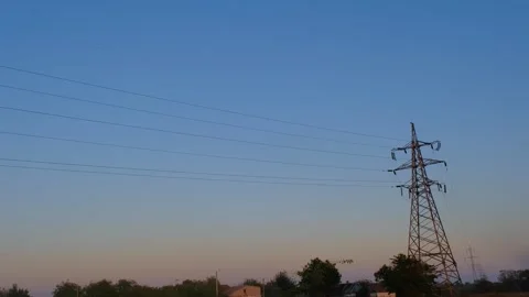 High voltage tower. High-voltage tower in a field against the blue sky. Static Stock-Footage 262770256