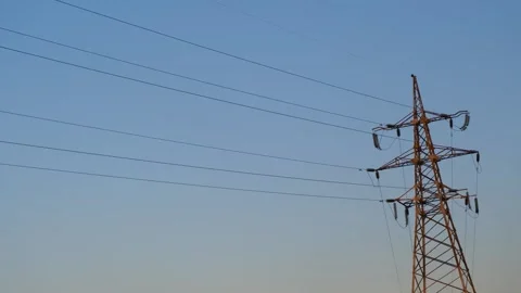 High voltage tower. High-voltage tower in a field against the blue sky. Static Stock Footage 263149611