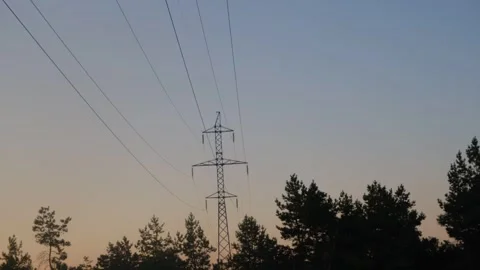 High voltage tower. High-voltage tower in a field against the blue sky. Static Stock Footage 263730600