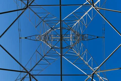 High voltage tower seen from underneath with blue sky Stock Photos