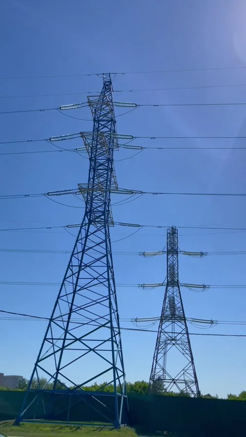 High voltage transmission tower along highway. Metal electrical pylon carrying Stock Footage 339432188