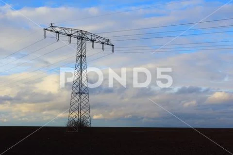 High voltage transmission tower in the evening dusk Stock Photos
