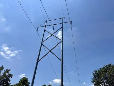 High Voltage Utility Power Pole Against Blue Sky Stock Photos