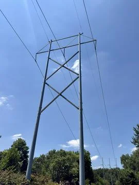 High Voltage Utility Power Pole Against Blue Sky Stock Photos