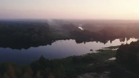 High-voltage wires thrown across a river in a wooded area. 스톡 동영상 164347335