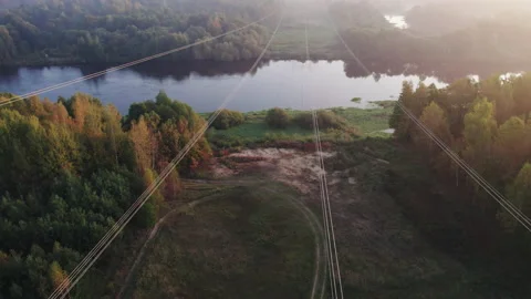 High voltage wires thrown across the river in a wooded area. 스톡 동영상 165293376