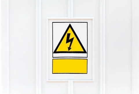 High voltage yellow triangle warning plate with an empty rectangle text box Stock Photos