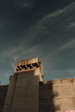 High wall with a tower with a dark sky in the background 스톡 사진