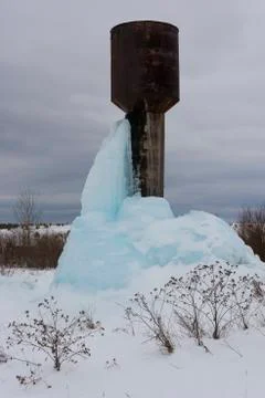 High water tower with a large block of blue ice. Stock Photos