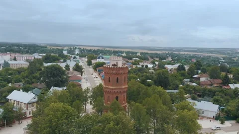 High water tower with terracotta bricks among city buildings 스톡 동영상 153089695