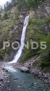 High waterfall in mountain wilderness Stock Photos