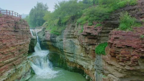 High waterfall in the mountains. Dramatic landscape of Waterfall in canyon. 스톡 동영상 133354038