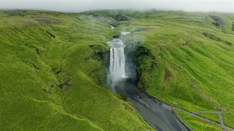 High Waterfall Surrounded by Lush Green Hills Video stock 319702402