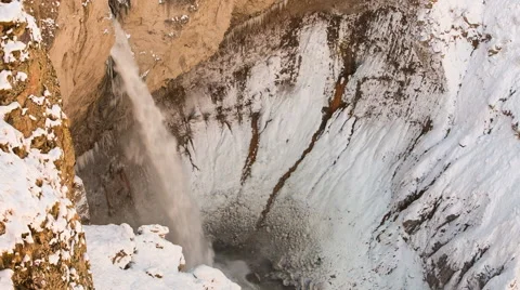 High waterfall in the tract Gil-Su high in the Caucasus mountains in winter Video stock 68907548