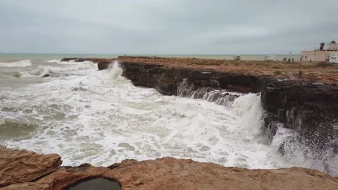 High wave breaking on the rocks of the coastline. Stock Footage 133808493