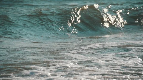 High wave hitting the sandy seacoast on a sunny day in summer in slow motion. Stock-Footage 119947315