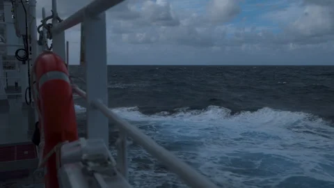 High waves and splashes along side. Ship in storm. White foam on sea. Deck Stock Footage 245388181