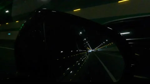 High-way tunnel view through side mirror of a fast-running car Stock Footage 152827970
