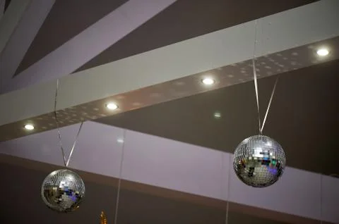 The high white ceiling with exposed beams. Decorated with disco balls.With the Stock Photos