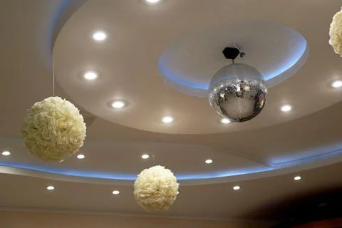 The high white ceiling with exposed beams. Decorated with disco balls.With the Stock Photos