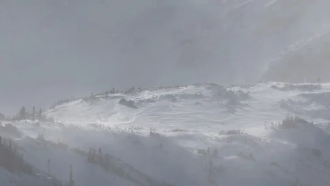 High wind blows snow over a mountain in ... | Stock Video | Pond5
