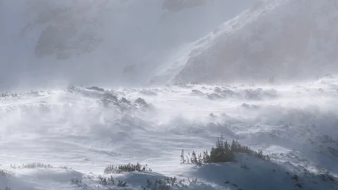 High wind blows snow over a mountain in a severe winter storm Stock Footage 93050594
