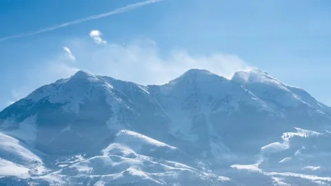 High winds on distant mountain peak timelapse Stock Footage 310537675