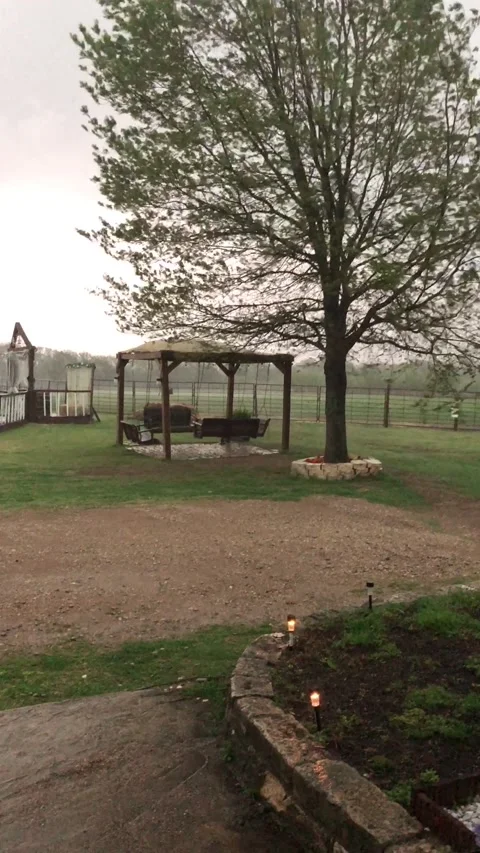 High Winds Send Anchored Down Trampoline Over Fence, Scurry, Texas, USA - 12 Apr Video stock 205425789