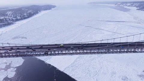 High winter drone shot of icy Quebec river and traffic bridges Stock Footage 328439924