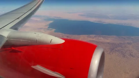Highaltitude Shot Capturing Passenger Plane Crossing Expansive Blue Lake Under Stock Footage 337938703