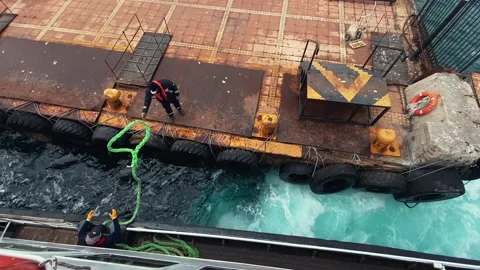 High‑angle: sailor throws mooring rope, ferry docking in Istanbul, slow motion Stock Footage 238979827