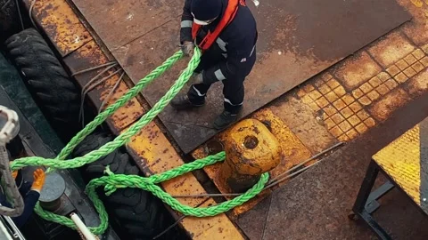 High‑angle: sailor throws mooring rope, ferry docking in Istanbul, slow motion Stock Footage 238979837