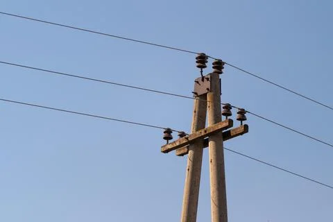 Highangle view of electric lines and poles, distant crossarms and multiple wi Foto stock
