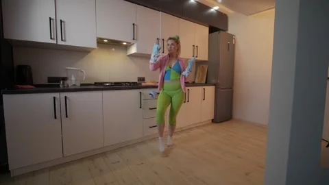 A highenergy and lively dance routine set in a contemporary kitchen environment Stock Footage 306159747