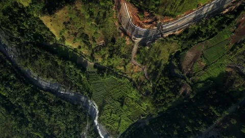Higher rotating aerial showcasing blue sky, rugged mountains, river channel Stock-Footage 331069139