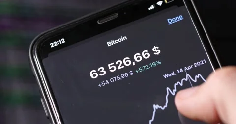 The highest point of the Bitcoin price is displayed on the phone Stock Footage 156017705
