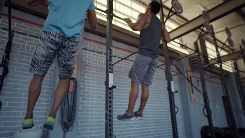Highfive after completing pull up at gym Stock Footage 71618337
