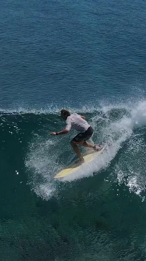 Highflying drone footage showcasing surfer navigating massive reef wave Stock Footage 322033656
