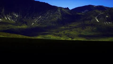 Highland landscape during twilight with dramatic mountains and shadows Stock Illustration