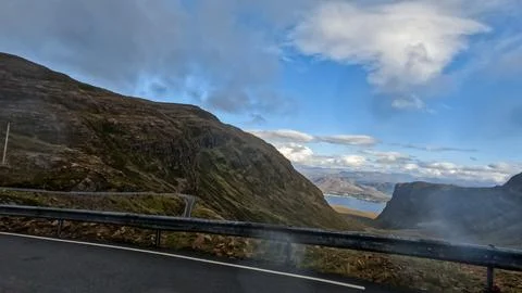 Highland road cuts through dramatic landscape Stock Photos