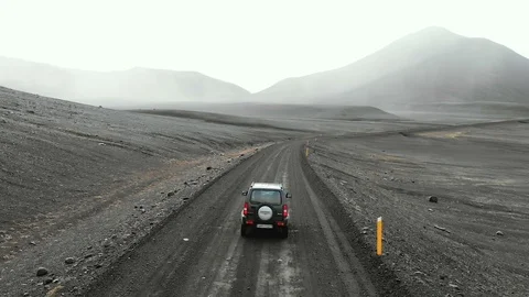 Highlands road through the lava fields in Iceland, aerial view of jeep. Stock Footage 120589845