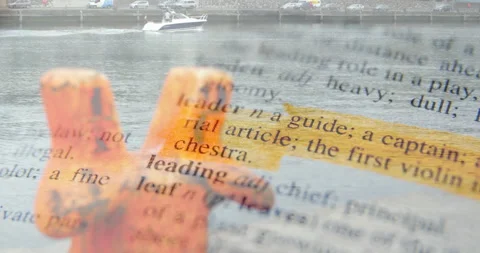 Highlighted dictionary definition of leader animation over boat on river Stock Footage 304102528